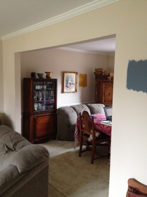Both rooms were the same color, though the dining room included a beat-up chair rail molding on the walls.